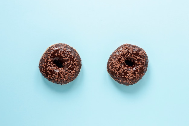 Top view arrangement with doughnuts and blue background