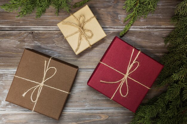 Free photo top view arrangement with gift boxes on wooden background