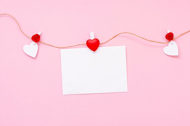 Top view arrangement with hearts and piece of paper