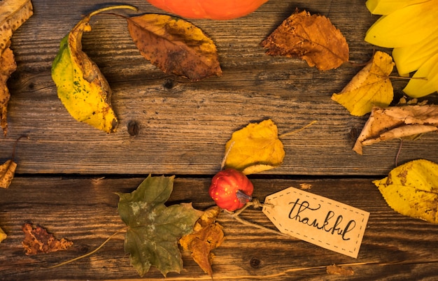 Top view arrangement with leaves on wooden background