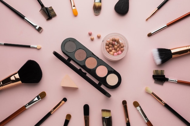 Top view arrangement with make-up brushes and palette