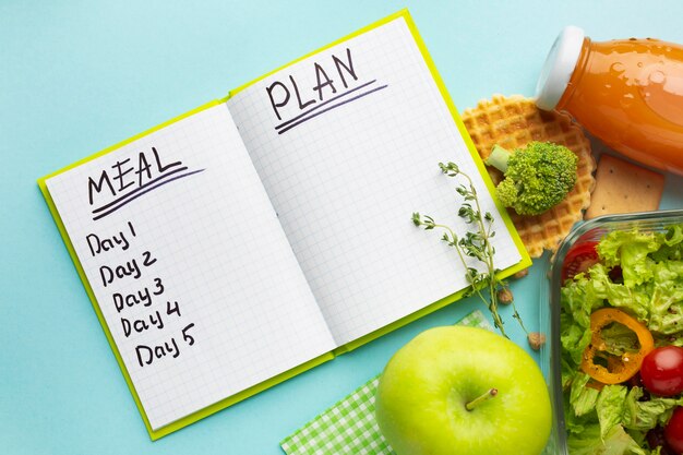 Top view arrangement with meal planning notebook