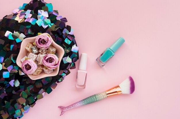 Top view arrangement with nail polish and make-up brush