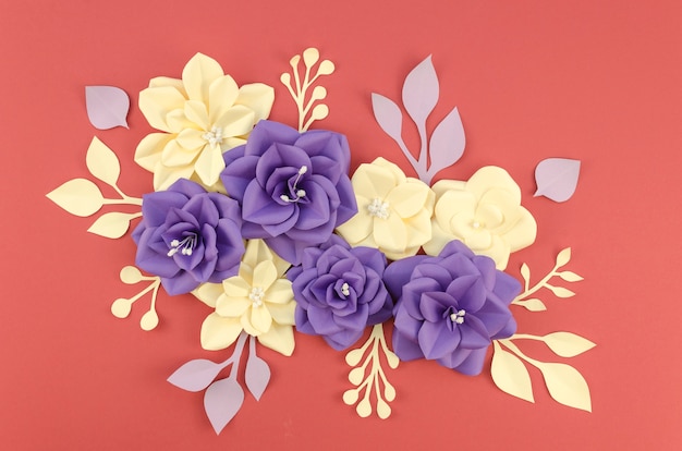 Top view arrangement with paper flowers and red background