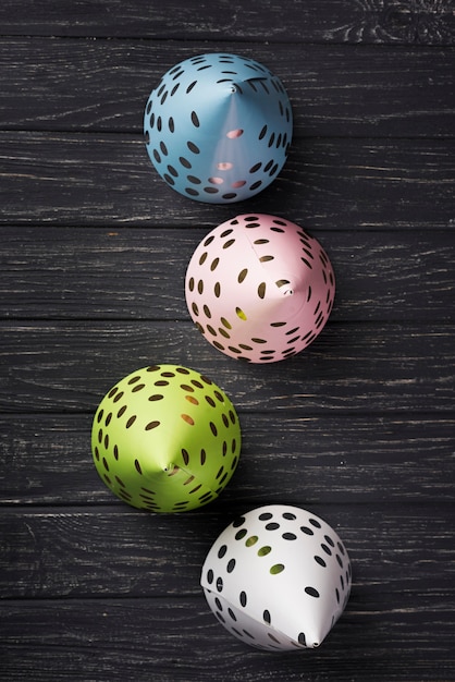 Top view arrangement with party hats on wooden background