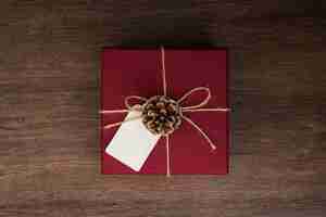 Free photo top view arrangement with present on wooden background