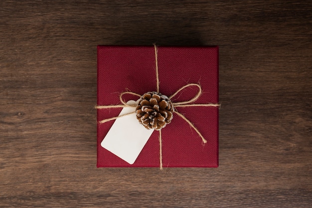 Top view arrangement with present on wooden background
