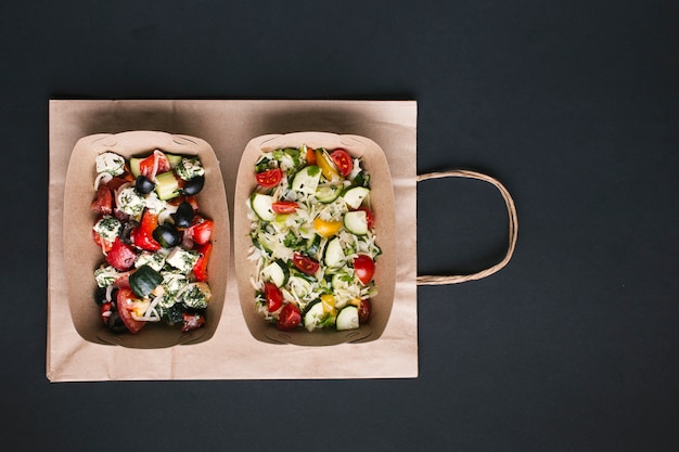 Free photo top view arrangement with salads on paper bag