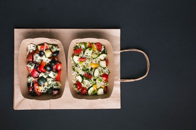 Top view arrangement with salads on paper bag