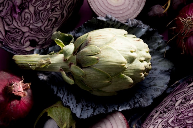 Free photo top view of artichoke on cabbage leaf