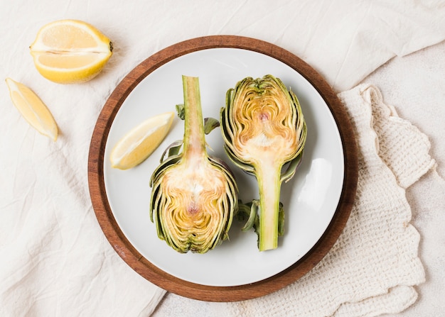 Top view of artichoke on plate with cloth