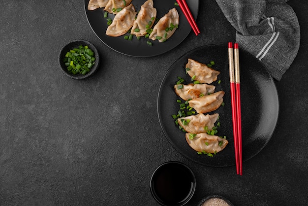 Free photo top view of asian dumplings dish with herbs