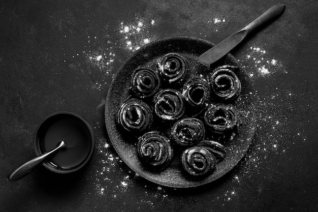 Top view assortment of black delicious food in dark plate