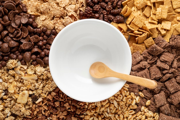 Top view of assortment of breakfast cereals with empty bowl