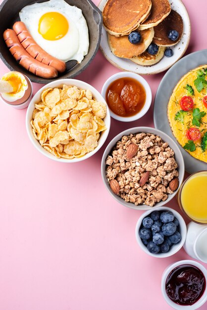 Top view of assortment of breakfast food with blueberries and jam