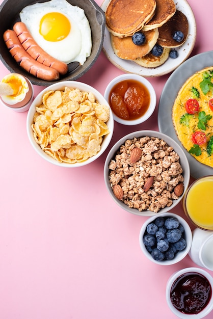 Top view of assortment of breakfast food with blueberries and jam