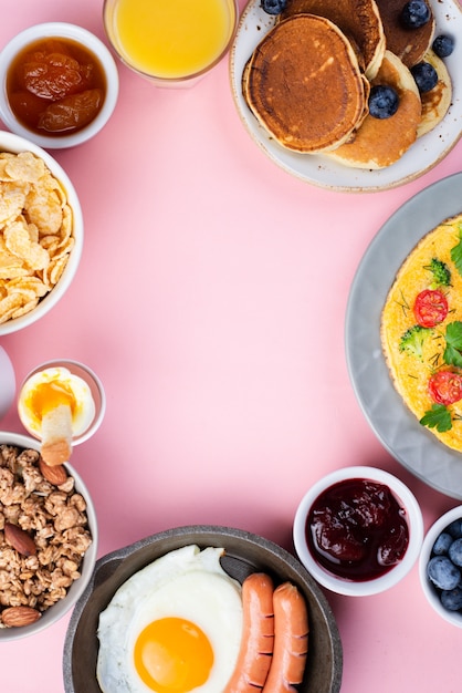 Top view of assortment of breakfast food with egg and sausages