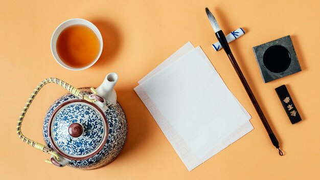 Top view assortment of chinese ink with empty paper