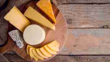 Free photo top view assortment of delicious cheese on the table