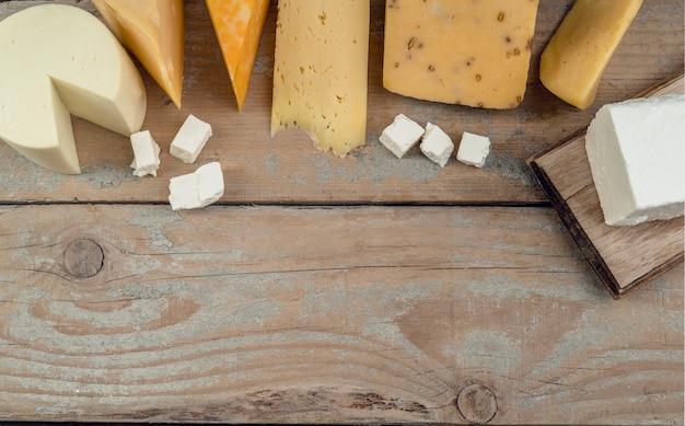 Top view assortment of delicious cheese on the table