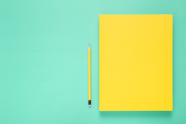 Top view assortment of desk elements on green background