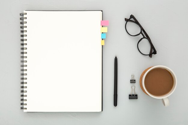 Top view assortment of desk elements on grey background