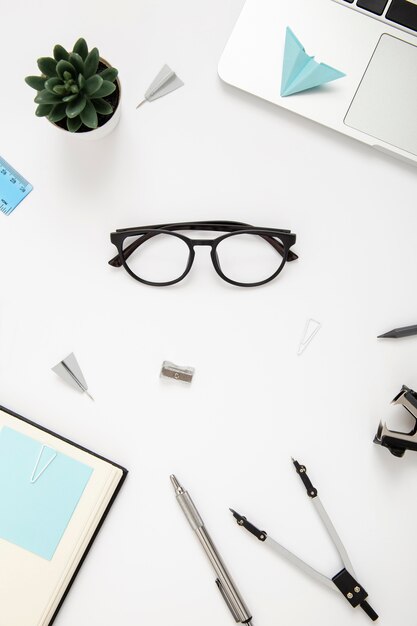 Top view assortment of desk elements on white background