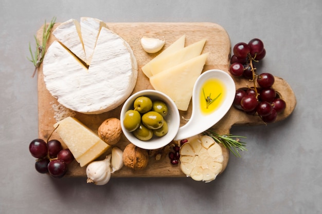 Top view assortment of different delicacies on wooden board