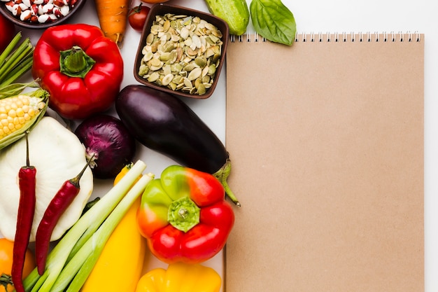 Top view assortment of different vegetables with empty notepad
