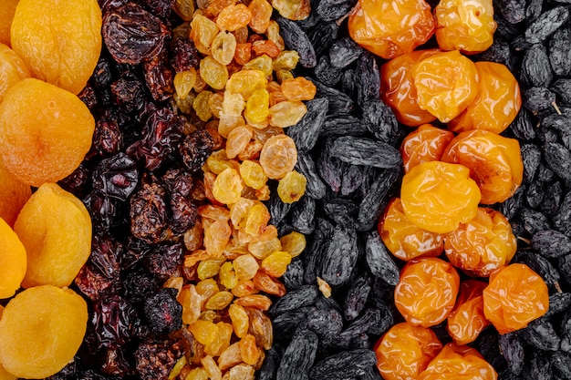 Top view of assortment of dried fruits apricots raisins cherries and cherry plums