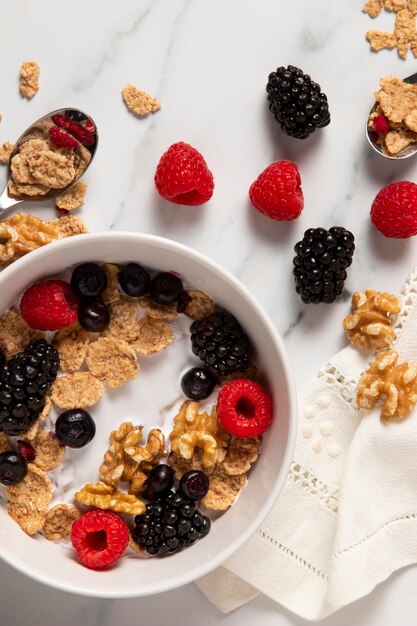 Top view assortment of healthy bowl cereals with berries