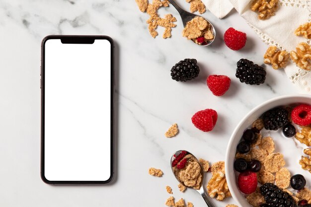 Top view assortment of healthy bowl cereals with empty screen smartphone