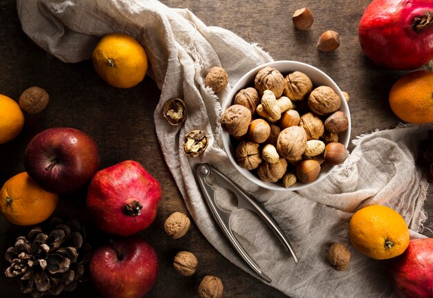 Top view of assortment of nuts with autumn fruit