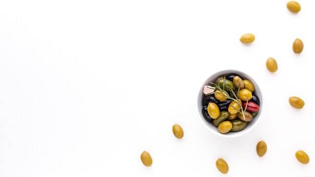 Top view assortment of olives in bowl with copy space