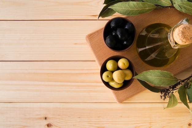 Top view assortment of olives and oil