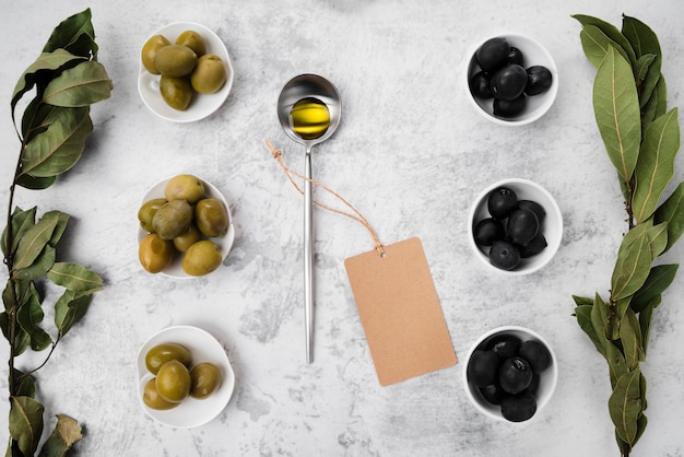 Top view assortment of olives and oil