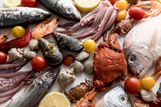 Top view of assortment of seafood with tomatoes