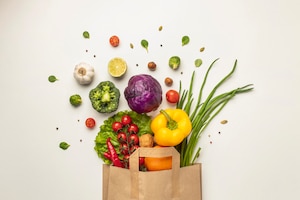 Top view of assortment of vegetables in paper bag