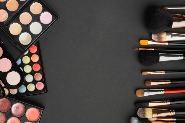 Top view assortment with make-up brushes and palettes