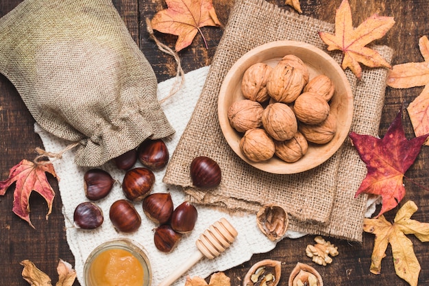 Top view autumn arrangement with nuts and honey