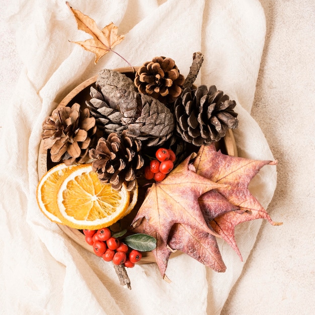 Top view of autumn arrangement with pine cones and leaves