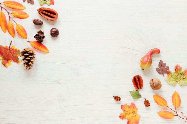 Top view autumn arrangement with wooden background