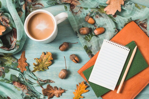 Top view autumn composition with coffee and notebooks