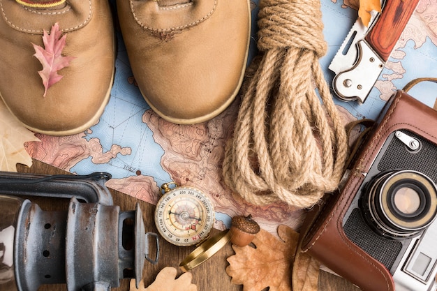 Top view of autumn essentials with boots and camera