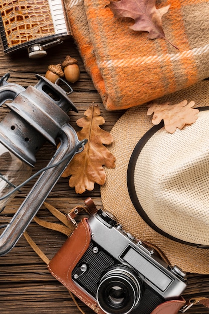 Top view of autumn essentials with hat and camera