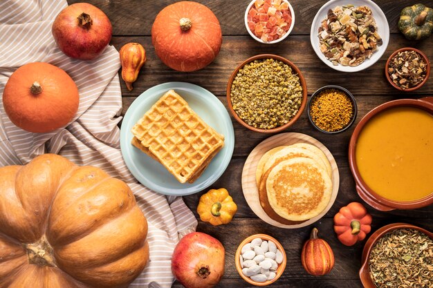 Top view autumn food on sheet and wooden background