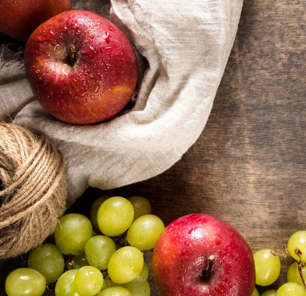 Top view of autumn grapes and apples with string