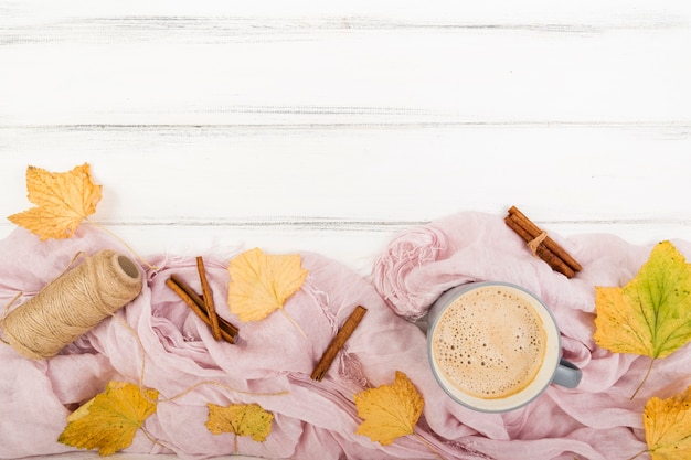 Free photo top view autumn leaves surrounded by coffee