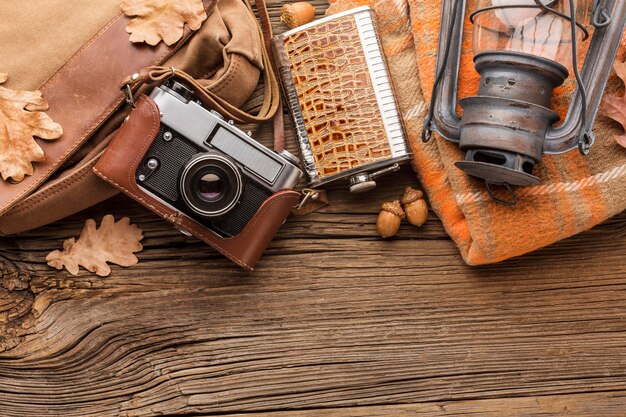 Top view of autumn leaves with camera and lantern