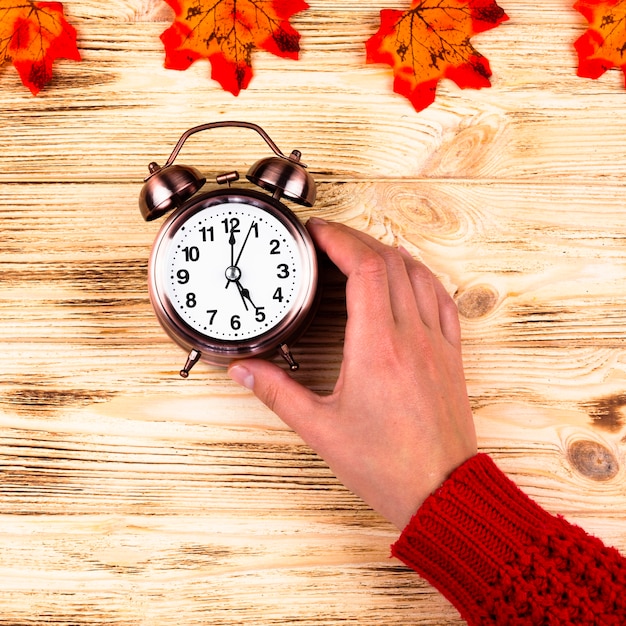 Top view autumn leaves with clock